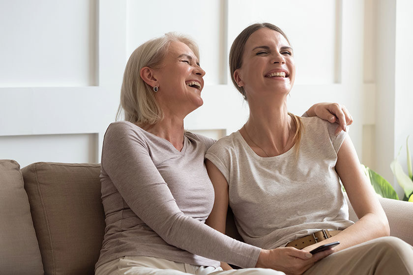 overjoyed-middle-aged-woman-laughing-at-funny-video