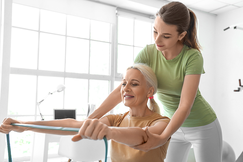 Mature woman training with elastic band