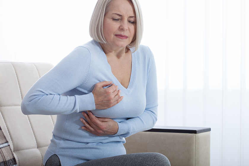 Portrait of middle aged woman having heart attack 