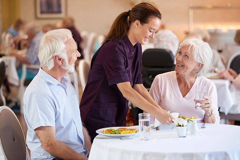 senior-couple-being-served-meal