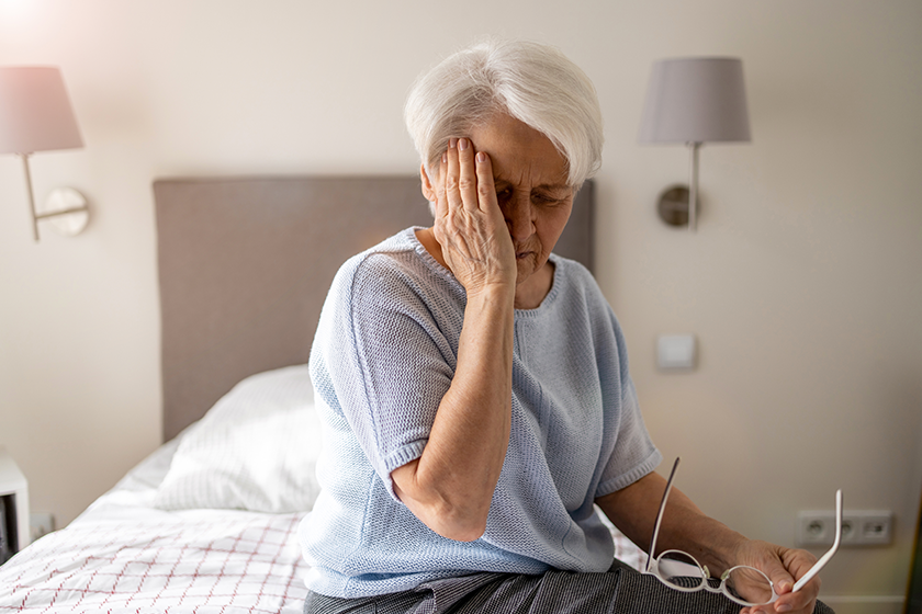 Senior woman suffering from a headache