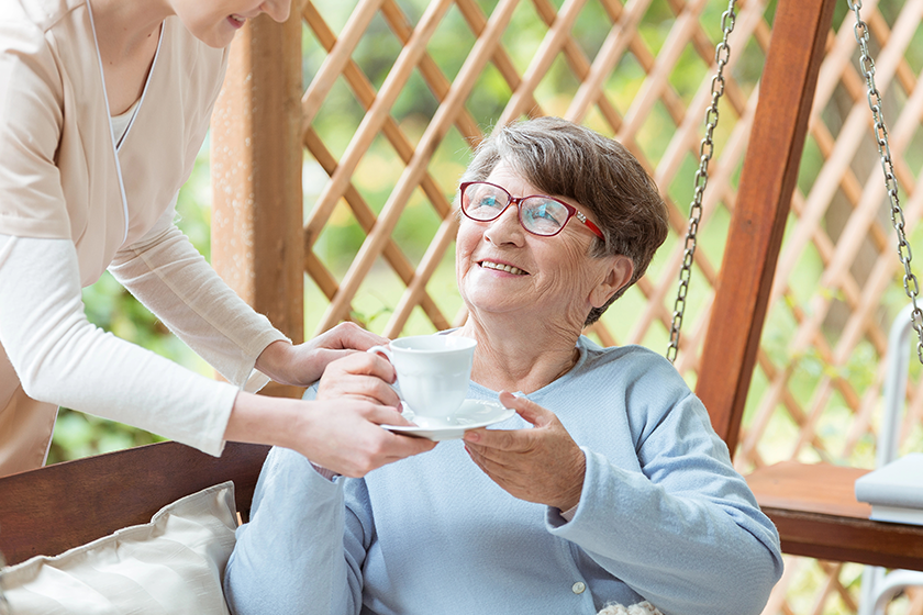 smiling-elder-with-cup-of-tea